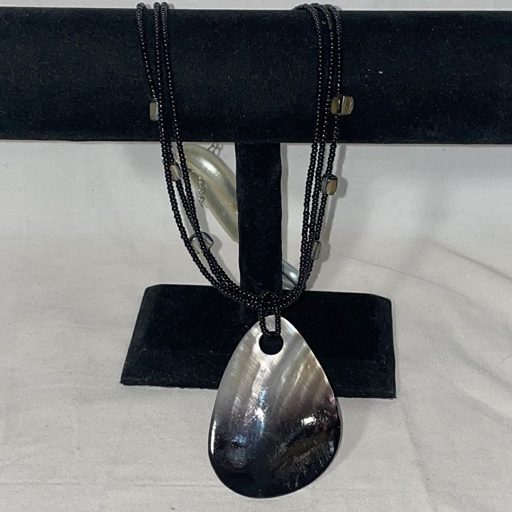 Beaded necklace with large shell emblem